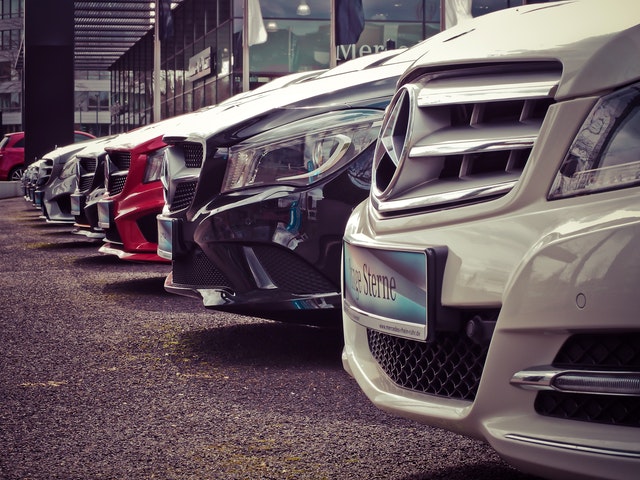 A display of luxurious vehicles, representing the pros and cons of importing used cars.